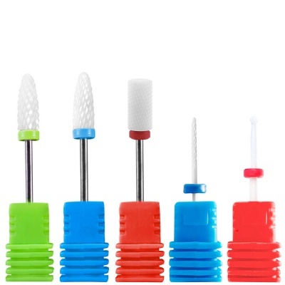 Cinco brocas de manicure com base plástica colorida em verde, azul e vermelho e pontas brancas de cerâmica.