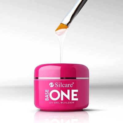 Frasco rosa de base de gel UV Silcare ONE com pincel aplicador e gel escorrendo