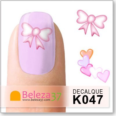 Unha lilás com decalque de laço rosa e decalques adicionais de laços e corações coloridos.