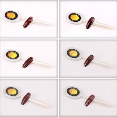 Régua branca com marcações amarelas e pretas e unha decorada castanha em fundo branco