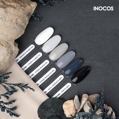 Amostras de unhas postsas coloridas em tons cinza, azul e preto com etiquetas de nomes e percentagens