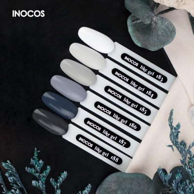 Mostruário de vernizes de unhas INOCOS tons neutros e cinzentos em fundo escuro com folhas verdes