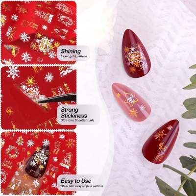 Autocolantes de unhas vermelhos com padrões dourados e brancos de flocos de neve