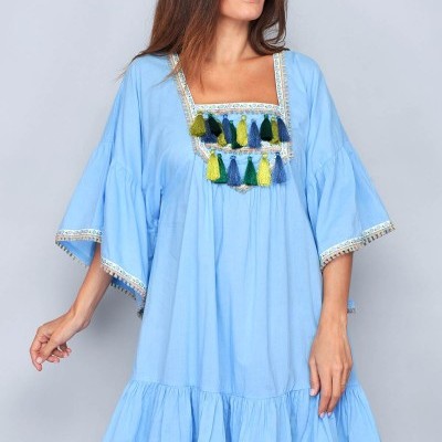 Vestido azul claro com franjas coloridas e mangas largas.