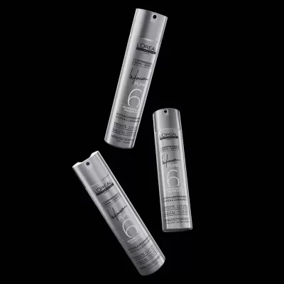 Frascos prateados de spray capilar L'Oréal Professionnel em fundo preto