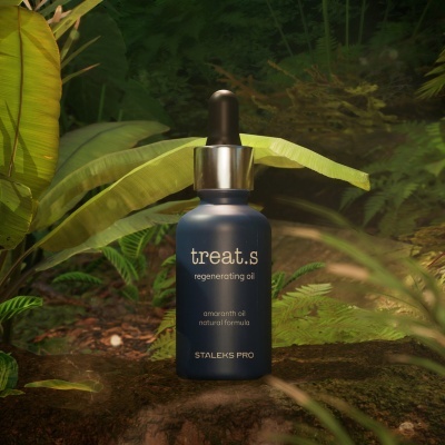 Frasco azul de óleo regenerador treat.s com conta-gotas em ambiente natural com plantas verdes