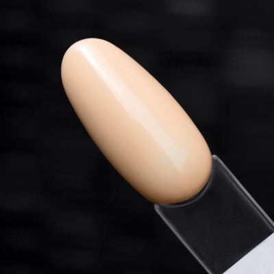 Amostra de verniz para unhas bege claro num suporte transparente