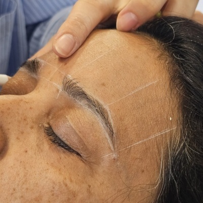 Rosto feminino com sobrancelha desenhada para mapeamento estético