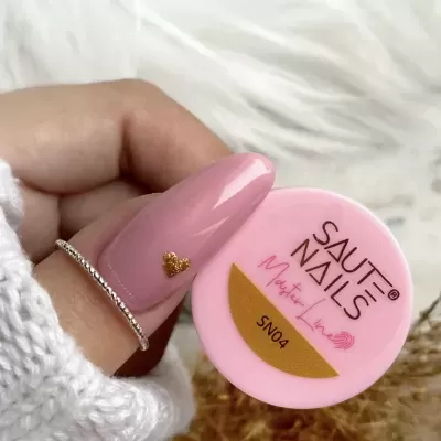 Pó de unhas SAUTE NAILS em embalagem rosa com unha rosa e coração dourado