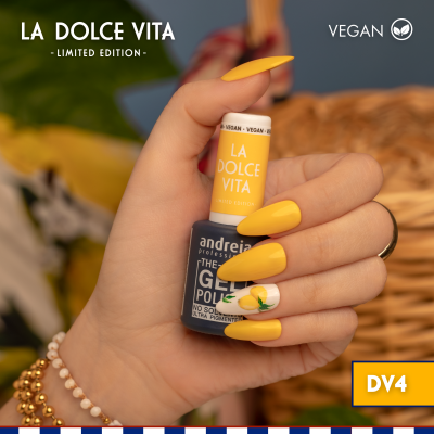 Frasco de verniz gel amarelo La Dolce Vita na mão com unhas pintadas amarelas e limão decorativo.