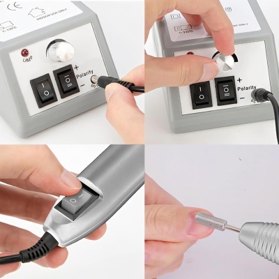 Máquina elétrica para manicure com controles e broca a ser usada na unha.