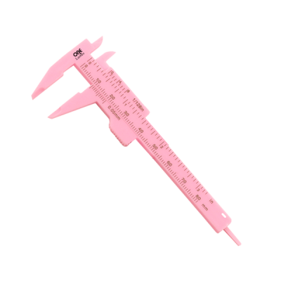 Paquímetro rosa de plástico com escala de medição em milímetros e polegadas