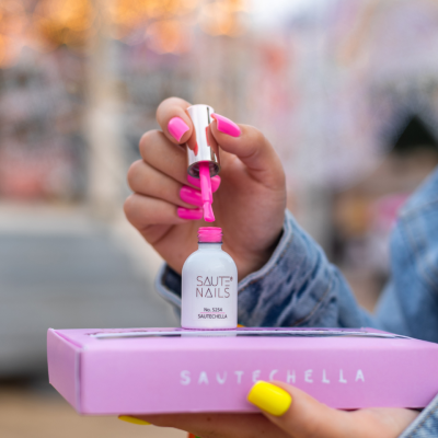 Frasco de verniz para unhas rosa SAUTE NAILS e caixa rosa SAUTECHELLA ao ar livre