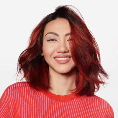 Mulher com cabelo vermelho e camisola vermelha de riscas finas