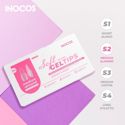 Embalagem branca de tips para unhas INOCOS Soft Gel Tips S2 Medium Almond sobre papéis cor-de-rosa e lilás.