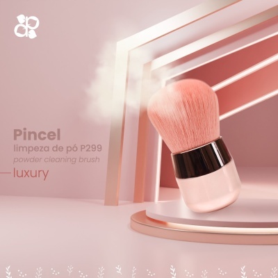 Pincel de limpeza de pó rosa com cabo e pelo macio em fundo rosa minimalista