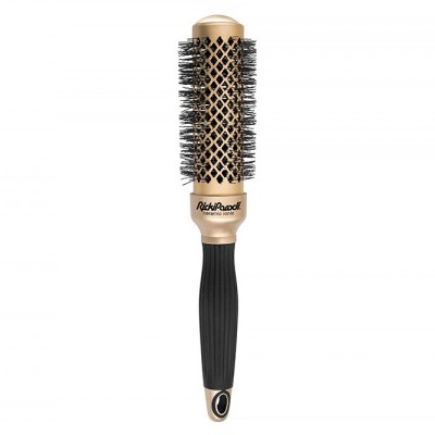 Escova redonda para cabelo dourada e preta sobre fundo branco