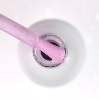 Pincel de verniz de unha rosa claro com brilho dentro do frasco aberto