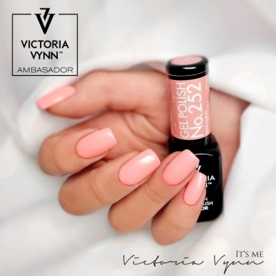 Mão com unhas pintadas de verniz gel rosa claro segurando frasco de verniz gel No.252 da marca Victoria Vynn.