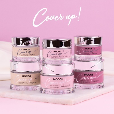 Seis frascos de gel camuflagem INOCOS em tons bege e rosa com tampa prateada, dispostos em duas fileiras sobre superfície rosa