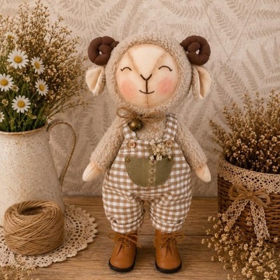 Boneco de ovelha em tecido com calças xadrez e botas, em ambiente rústico com flores e barbante