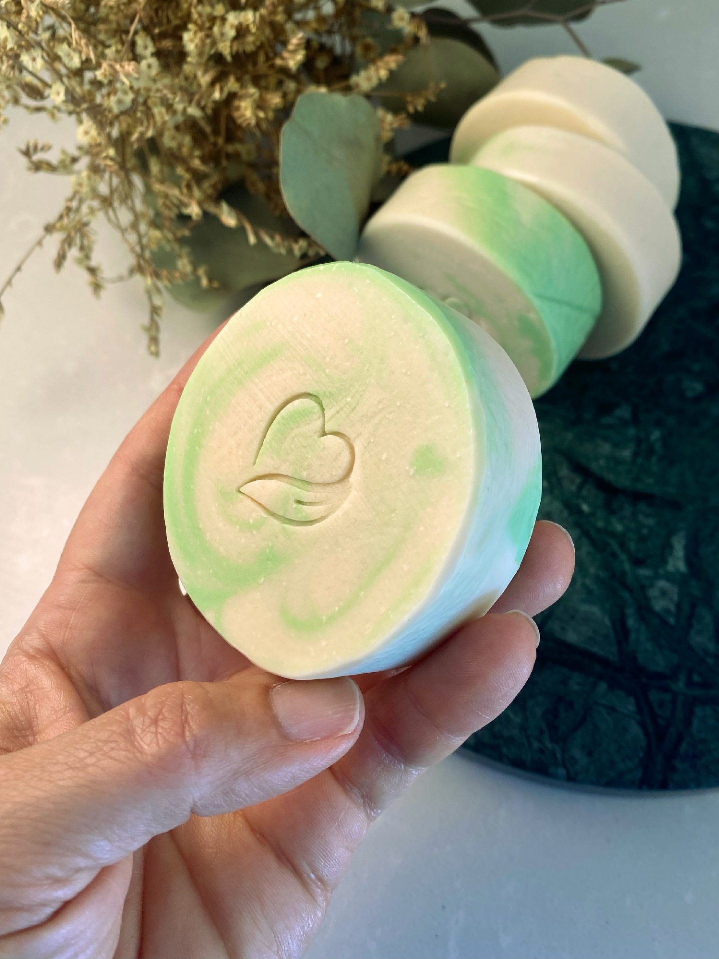 Sabonete natural de vinho branco Sabonete redondo creme e verde com símbolo de coração e folha