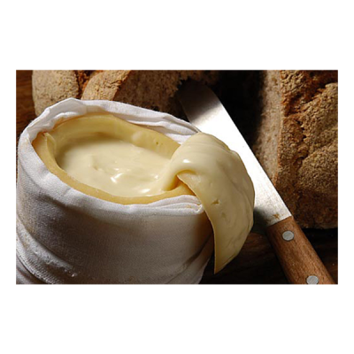 Queijo cremoso em pano branco com faca e pão