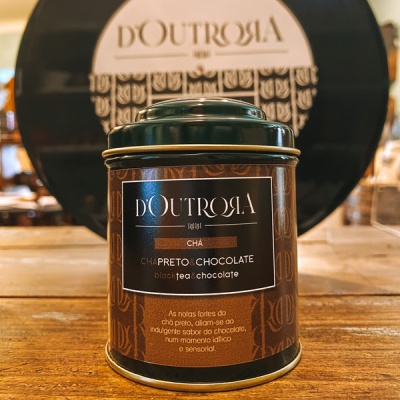 Lata de chá preto chocolate DOUTROIA em lata castanha e preta sobre mesa de madeira