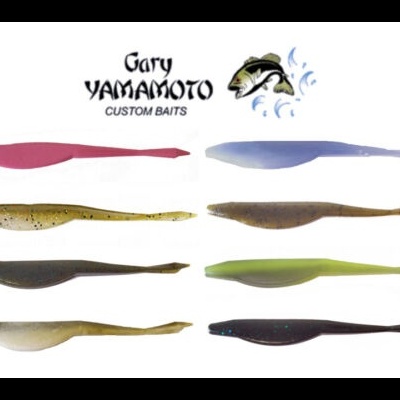 Oito iscas de pesca artificiais Gary Yamamoto de várias cores dispostas em linhas.