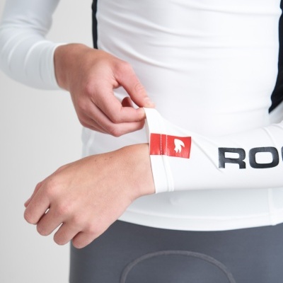 Camisola desportiva branca de manga comprida com logo vermelho e texto preto na manga