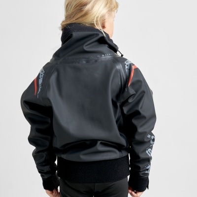 Criança loira de costas com casaco preto com detalhes cinzentos e vermelhos.