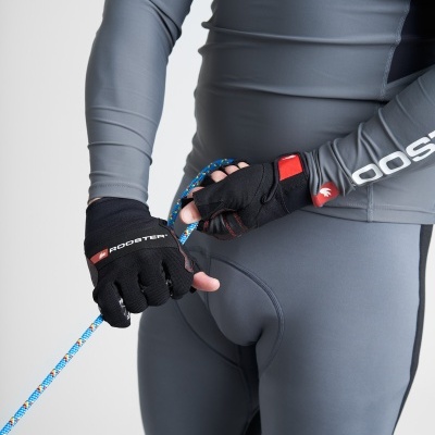 Pessoa com roupa desportiva cinza e luvas pretas segurando corda azul.