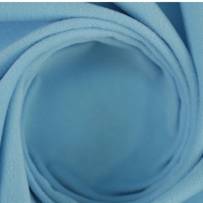 Tecido azul claro enrolado em espiral com textura suave