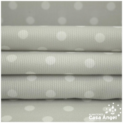 Tecidos cinza claro com bolinhas brancas e logótipo Casa Angel