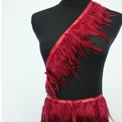 Acessório de penas vermelhas num manequim preto