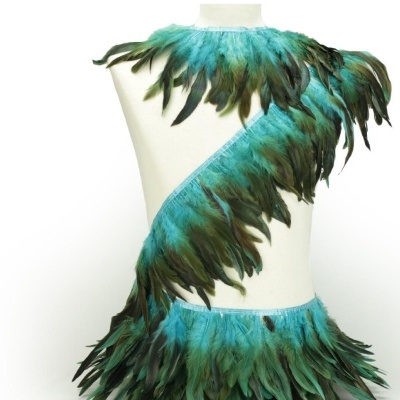Vestido com penas verdes e azuis em manequim branco