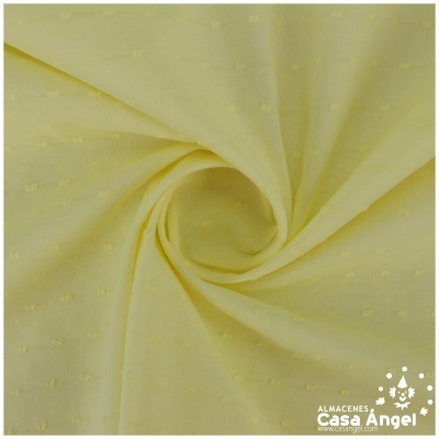 Tecido amarelo claro com padrão de pontos texturizados