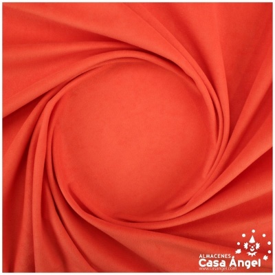 Tecido laranja vibrante com textura suave em formato circular