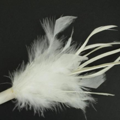 Acessório decorativo branco com penas sobre fundo preto