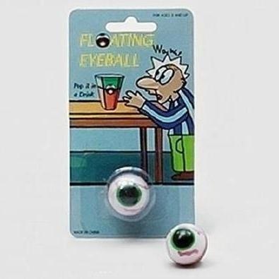 Bola flutuante com desenho de olho verde em embalagem azul com ilustração de personagem e texto