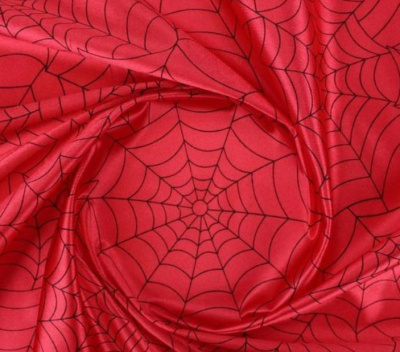Tecido vermelho com padrão de teia de aranha preto