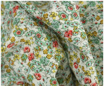 Tecido floral em algodão com padrões vermelhos, amarelos e verdes