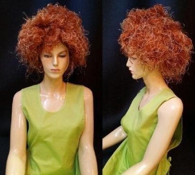 Mannequin with curly reddish-brown wig and light green sleeveless top