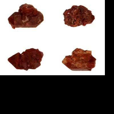 Quatro cristais castanho-avermelhados em fundo branco