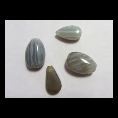 Pedras polidas em tons cinza e azul com riscas brancas sobre fundo branco.