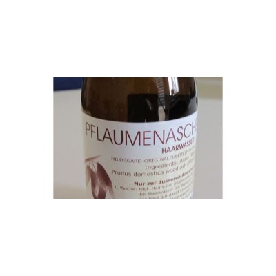 Frasco de produto capilar com rótulo branco e texto em alemão.