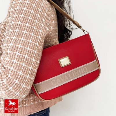 Mala de ombro vermelha Cavalinho com faixa bege bordada usada com casaco bege xadrez