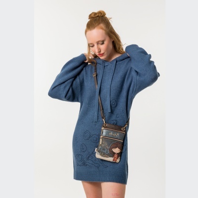 Mulher a usar vestido de malha azul e saco tiracolo ilustrado.