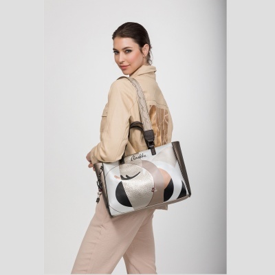 Mulher a segurar mala Anekke com padrão abstrato em tons neutros