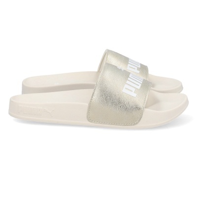 Chinelos Puma slide femininos bege com tira larga metálica dourada e logo branco